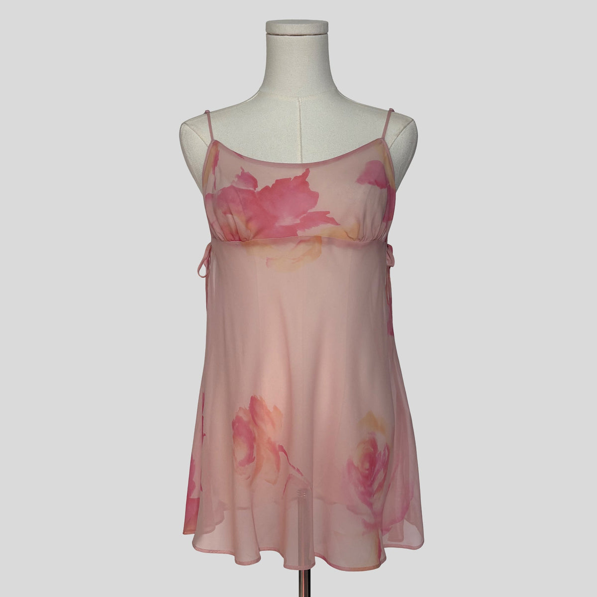 Silk slip dress with side cutouts and bows in sheer pink floral