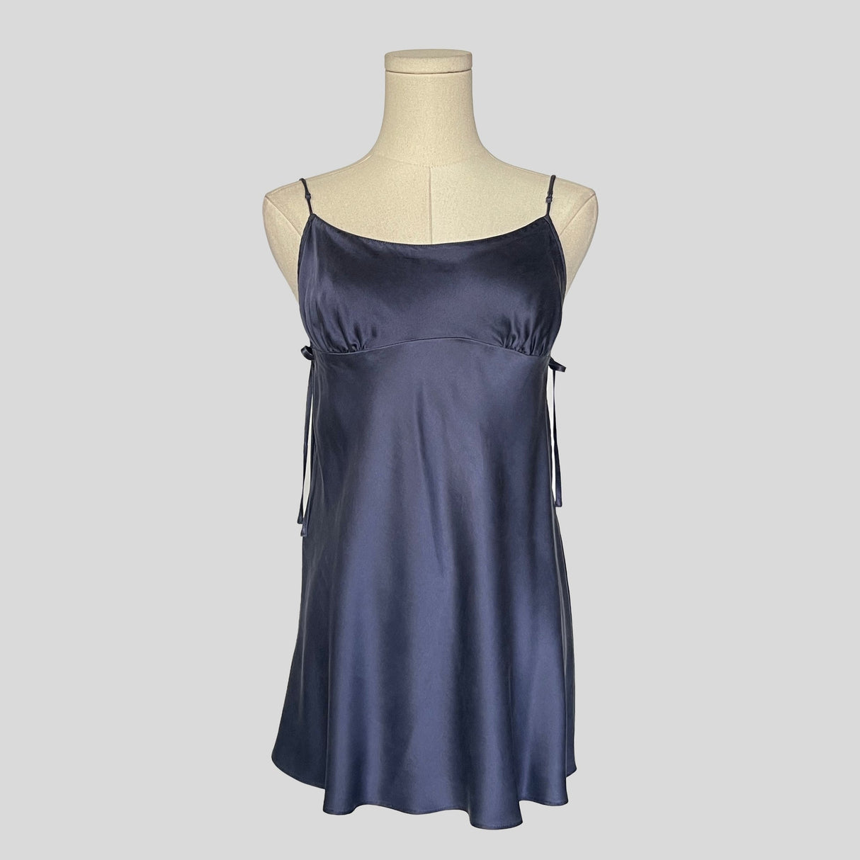 Silk slip dress with side cutouts and bows in navy