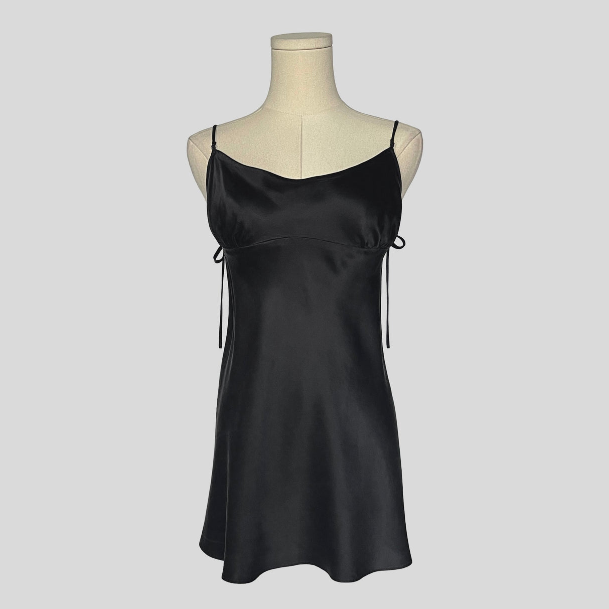 Silk slip dress with side cutouts and bows in black