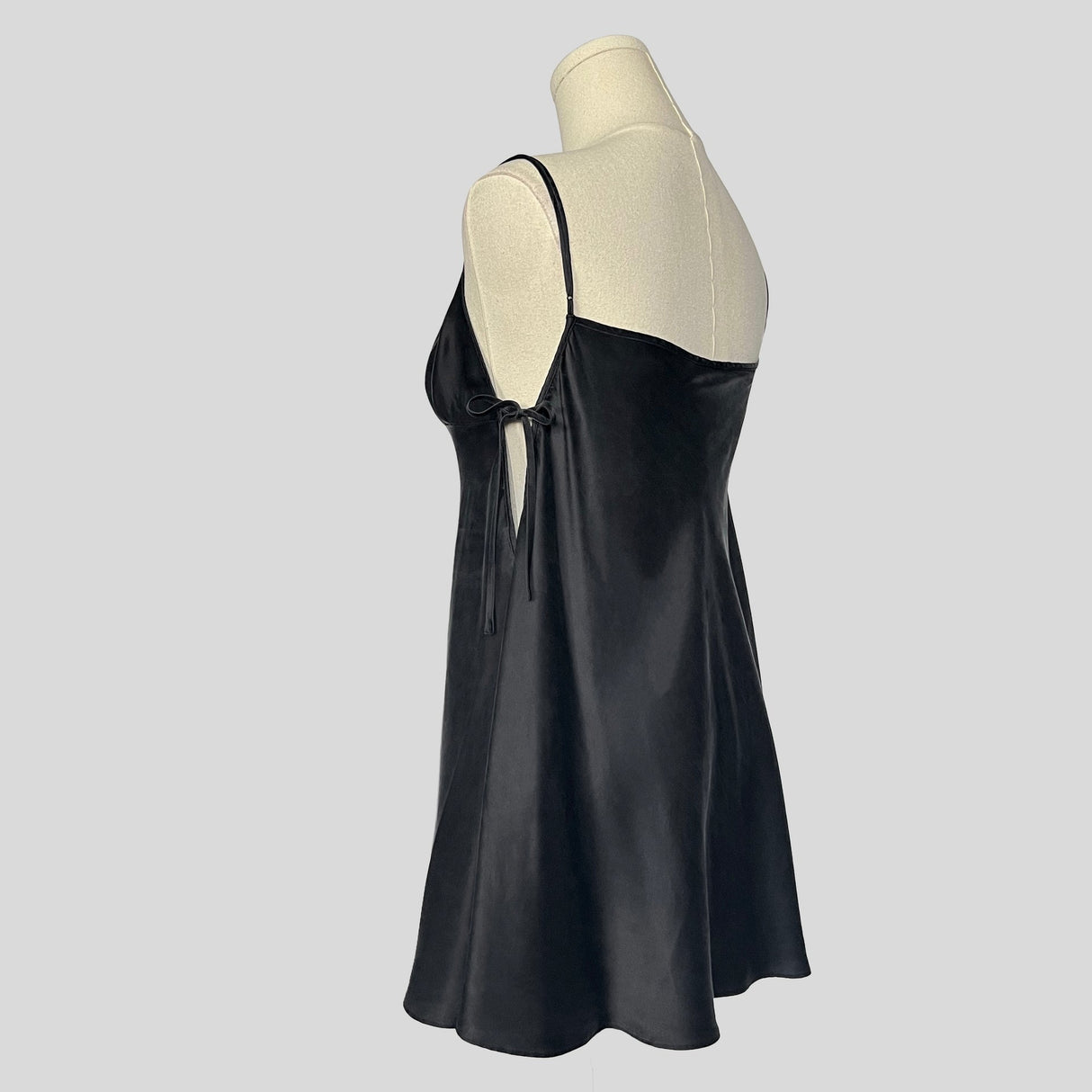 Silk slip dress with side cutouts and bows in black