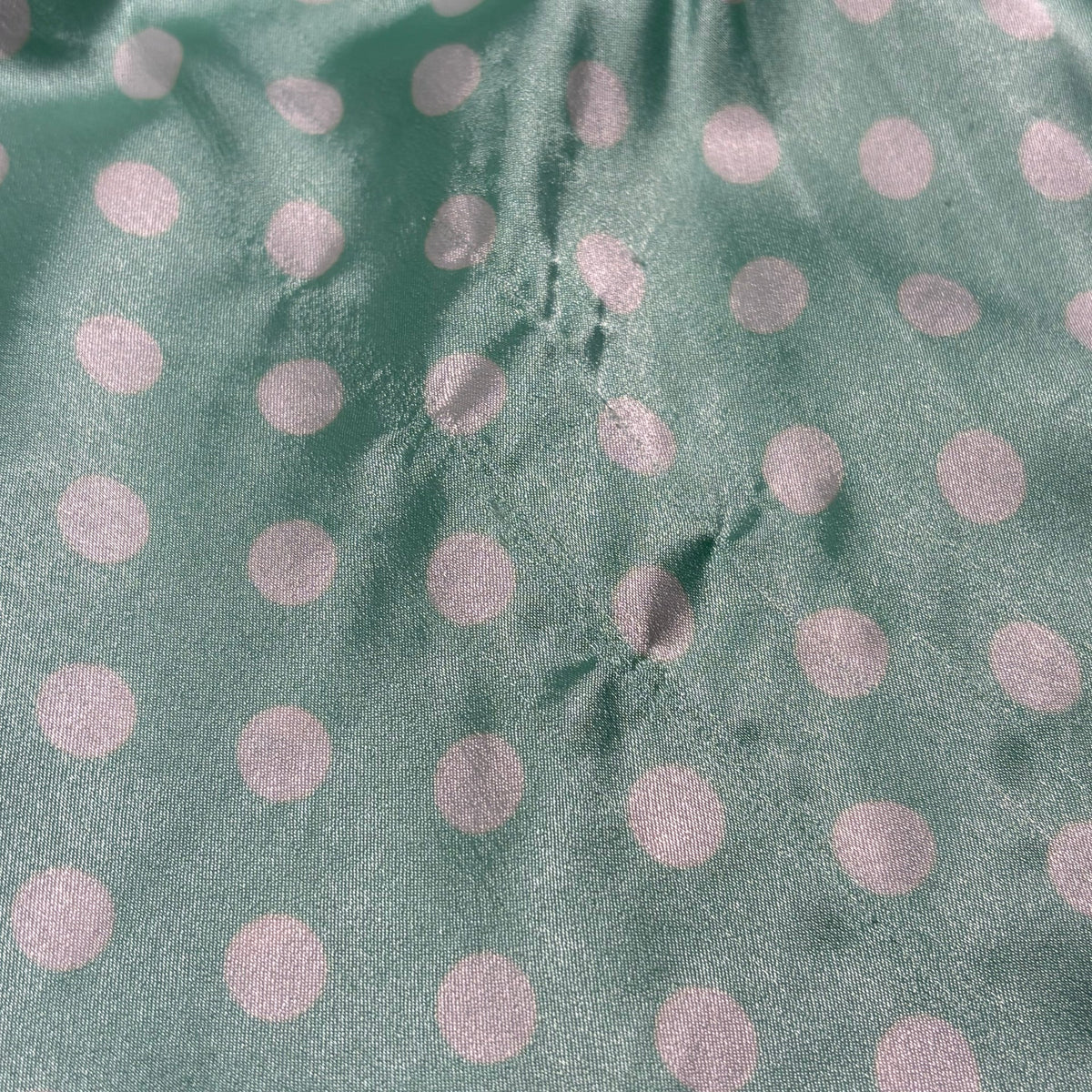Silky polka dot ruffled slip in teal and white