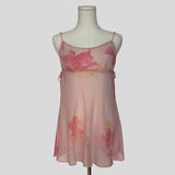 Silk slip dress with side cutouts and bows in sheer pink floral