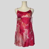 Silk slip dress with side cutouts and bows in pink floral