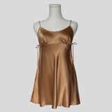 Silk slip dress with side cutouts and bows in gold