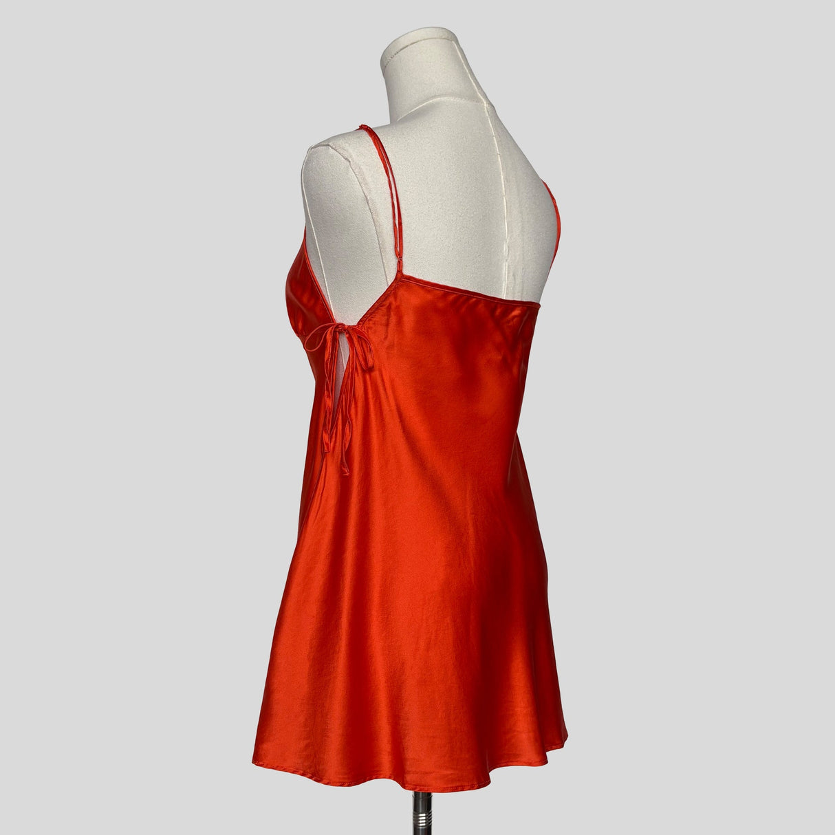 Silk slip dress with side cutouts and bows in orange