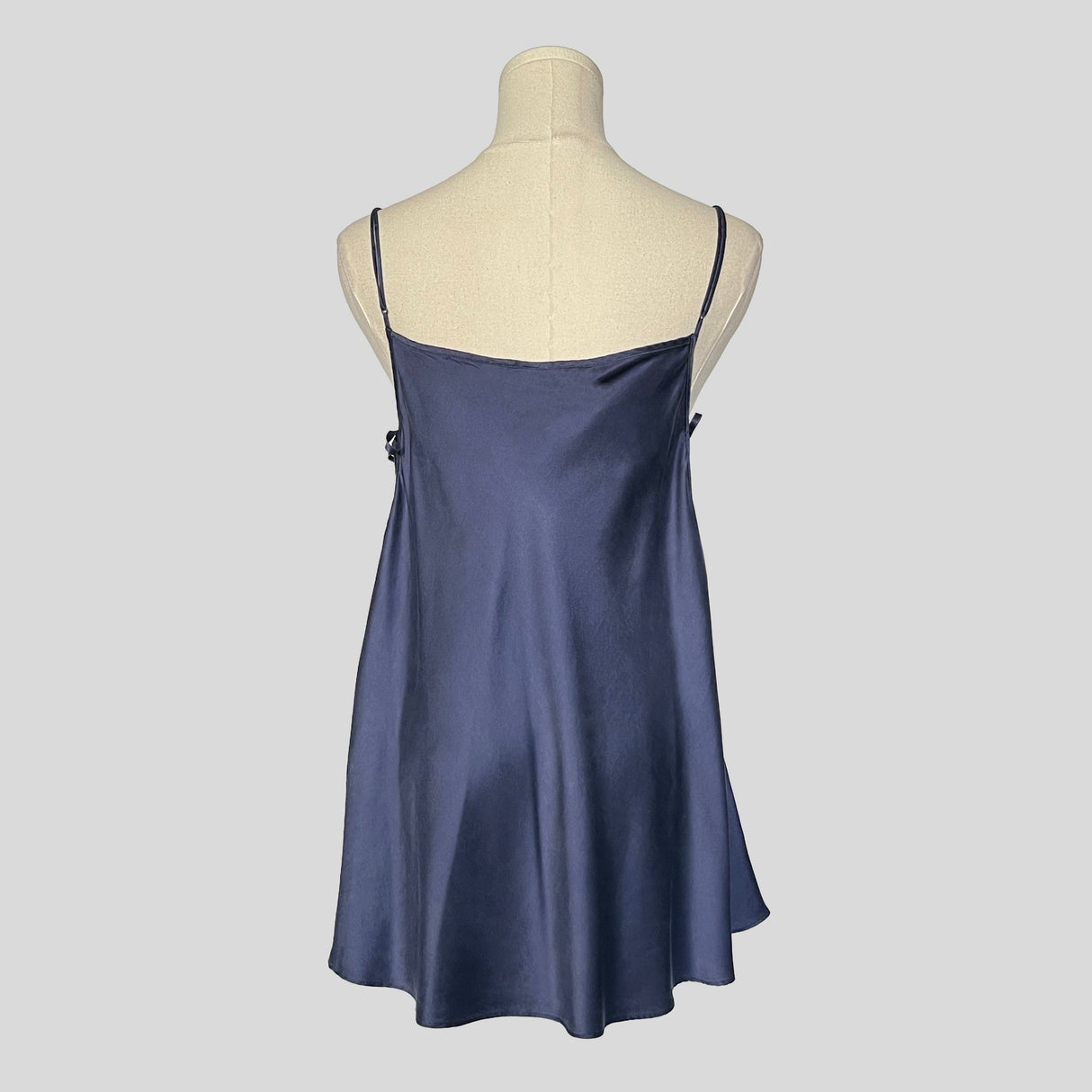 Silk slip dress with side cutouts and bows in navy