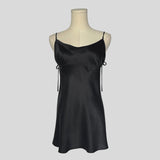Silk slip dress with side cutouts and bows in black