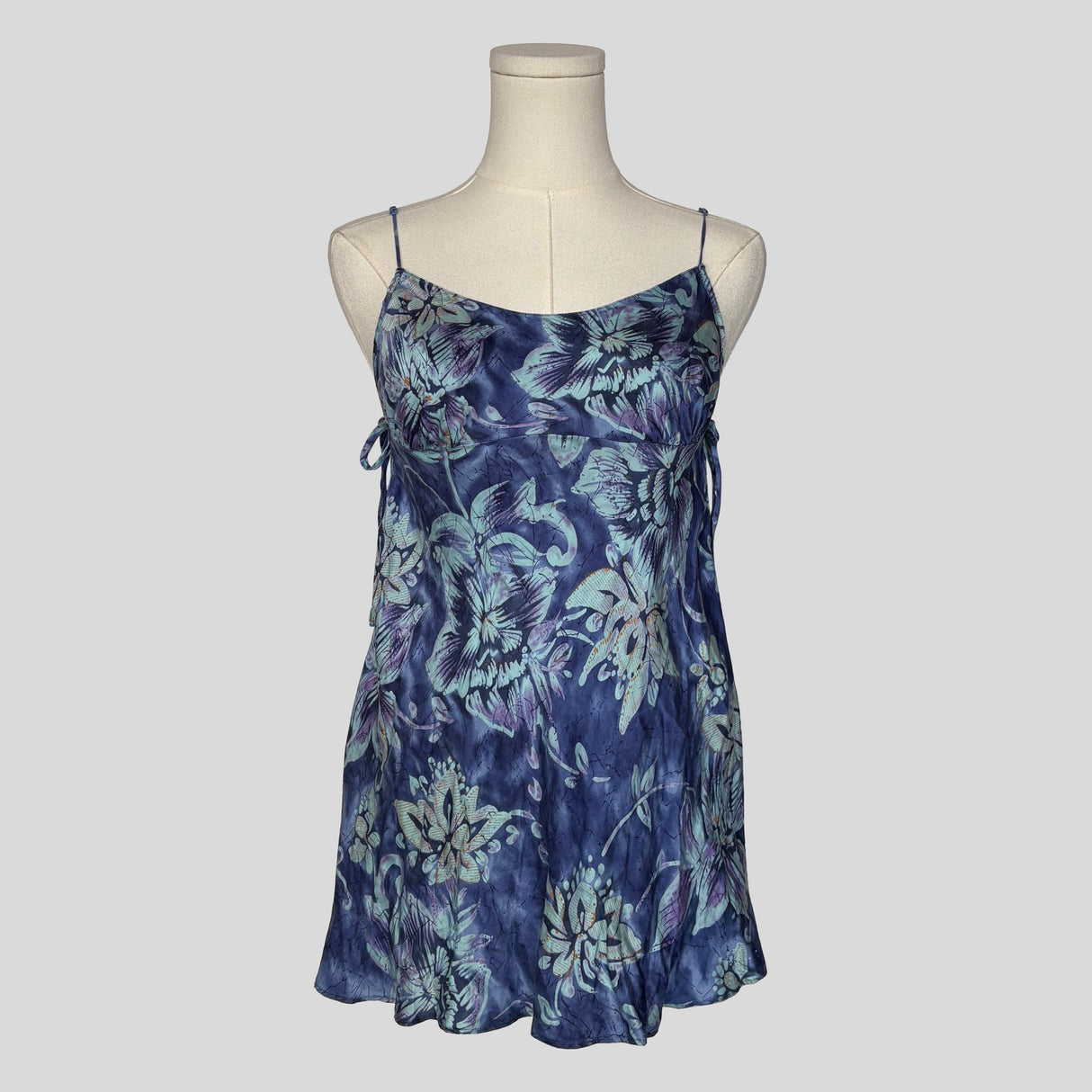 Silk slip dress with side cutouts and bows in blue floral