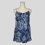 Silk slip dress with side cutouts and bows in blue floral