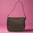 Brown checkered handbag with a visible brand logo on a white background